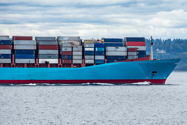 Blue cargo ship seen from the side